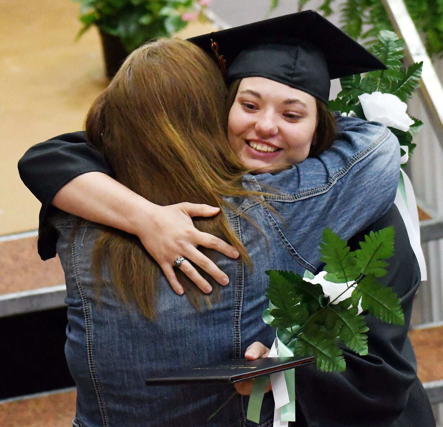 Elizabeth Eiler receives a hug after receiving her diploma.